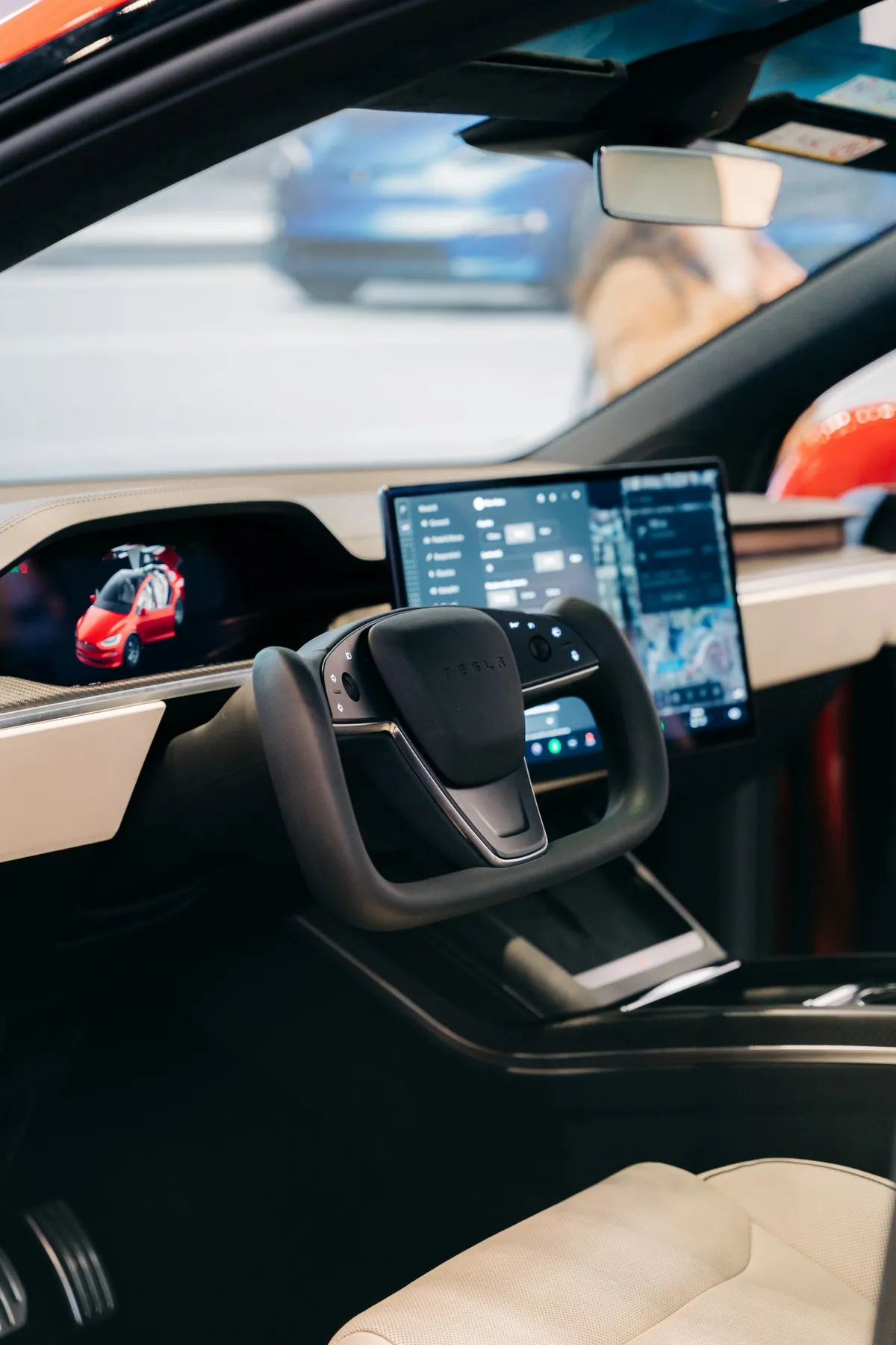 Tesla Model X cabin with yoke steering wheel and center display